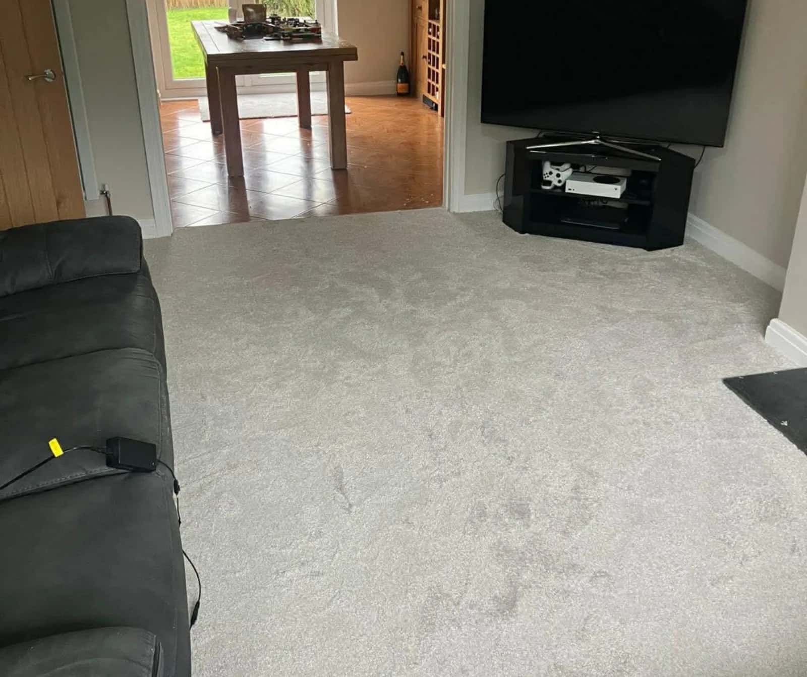 Light carpet fitted through a living room