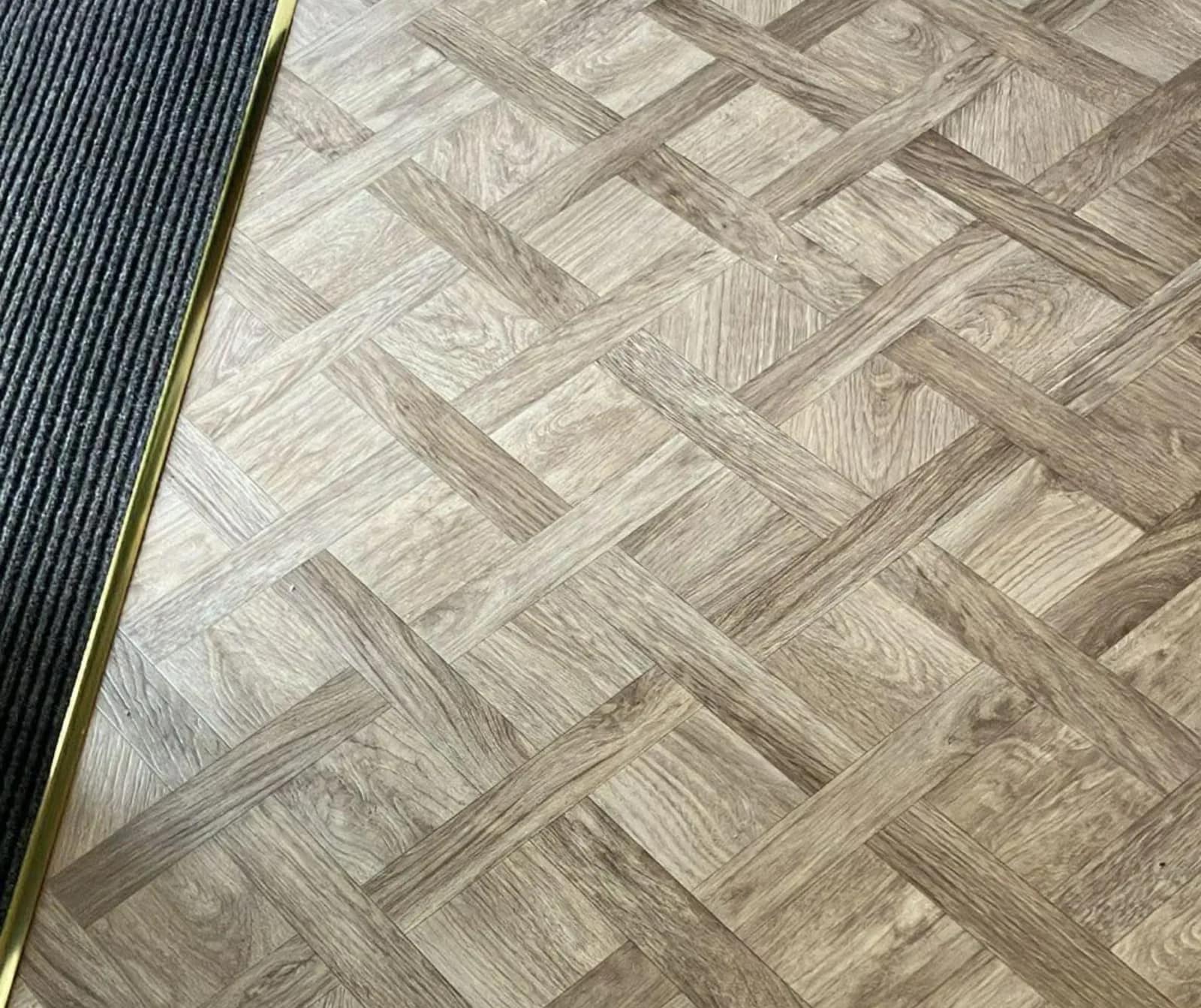 A parquet pattern wood effect floor laid in a basket weave