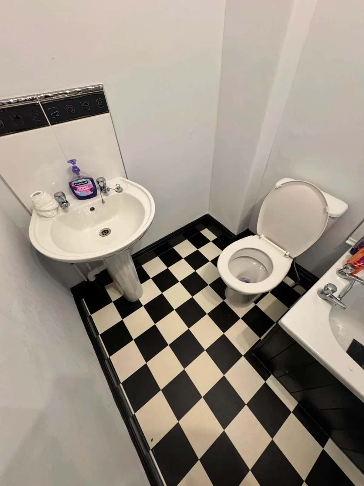 Chequerboard vinyl fitted around a basin and WC