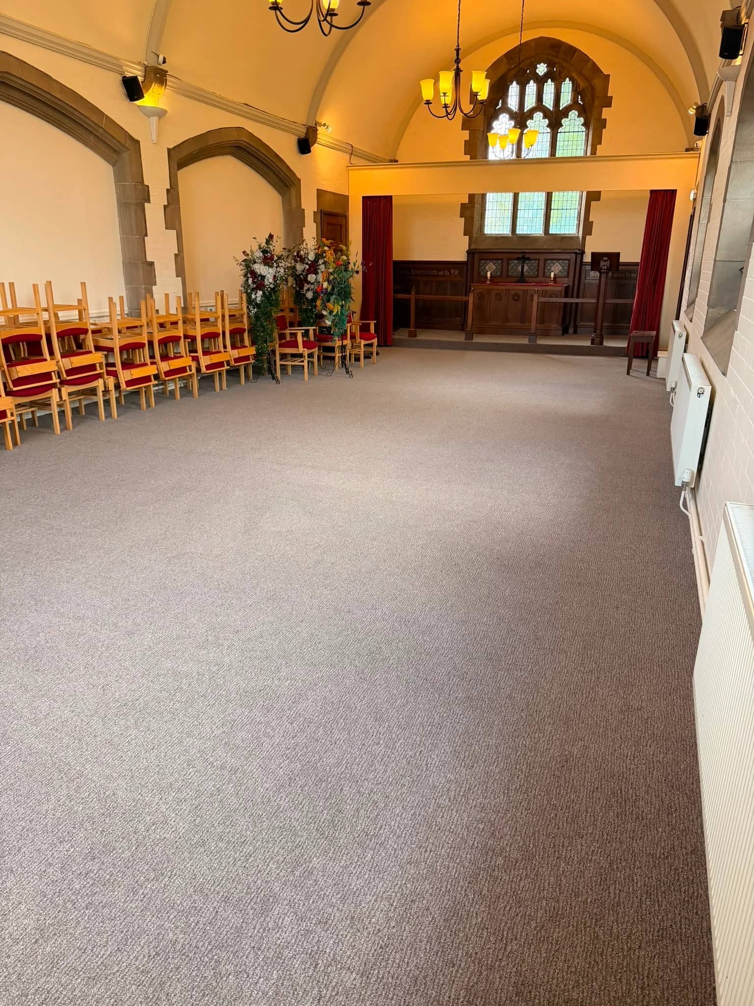 Commercial carpet fitted through the nave at Burnley Cemetery Chapel, running between the fixed seating