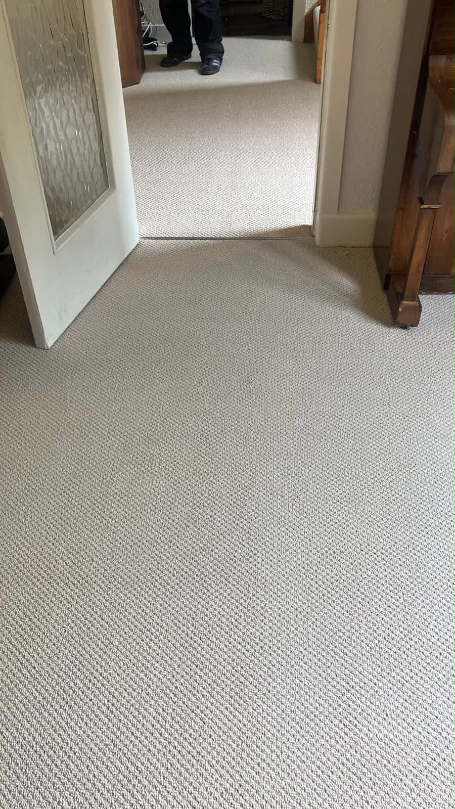 Cream carpet fitted through a doorway