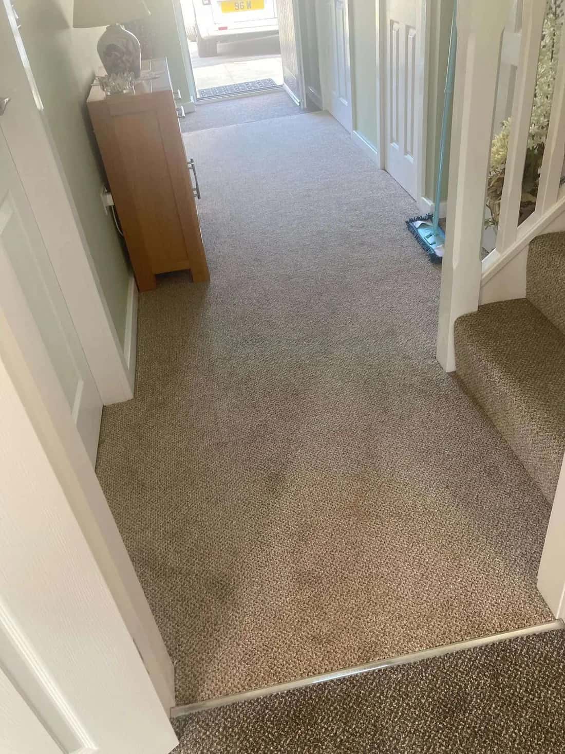 Beige carpet running the length of a hallway