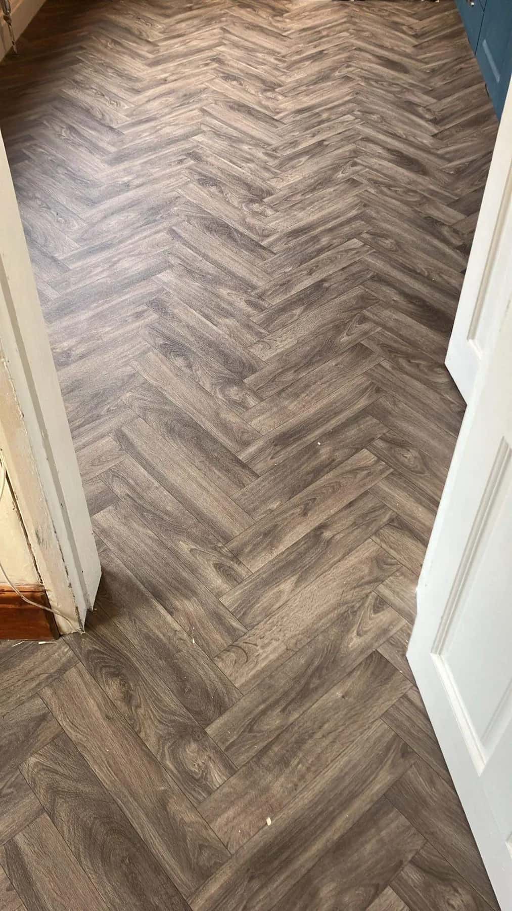 Warm toned herringbone luxury vinyl tile in a doorway