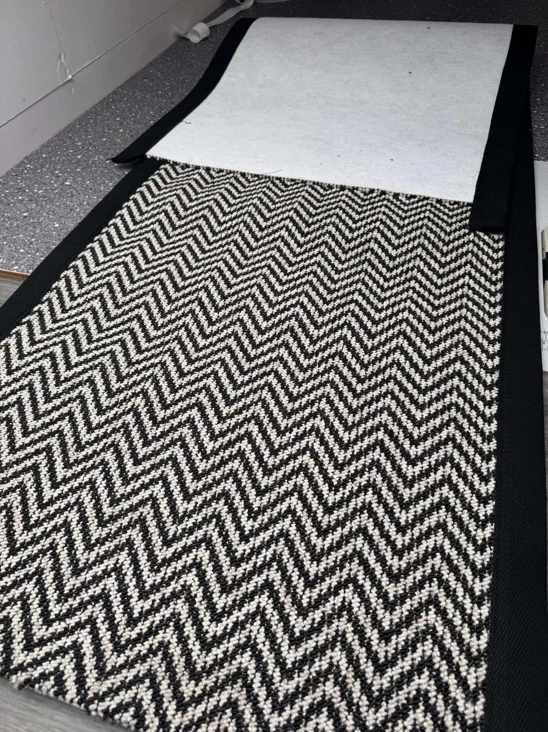 Herringbone runner with a black bound border