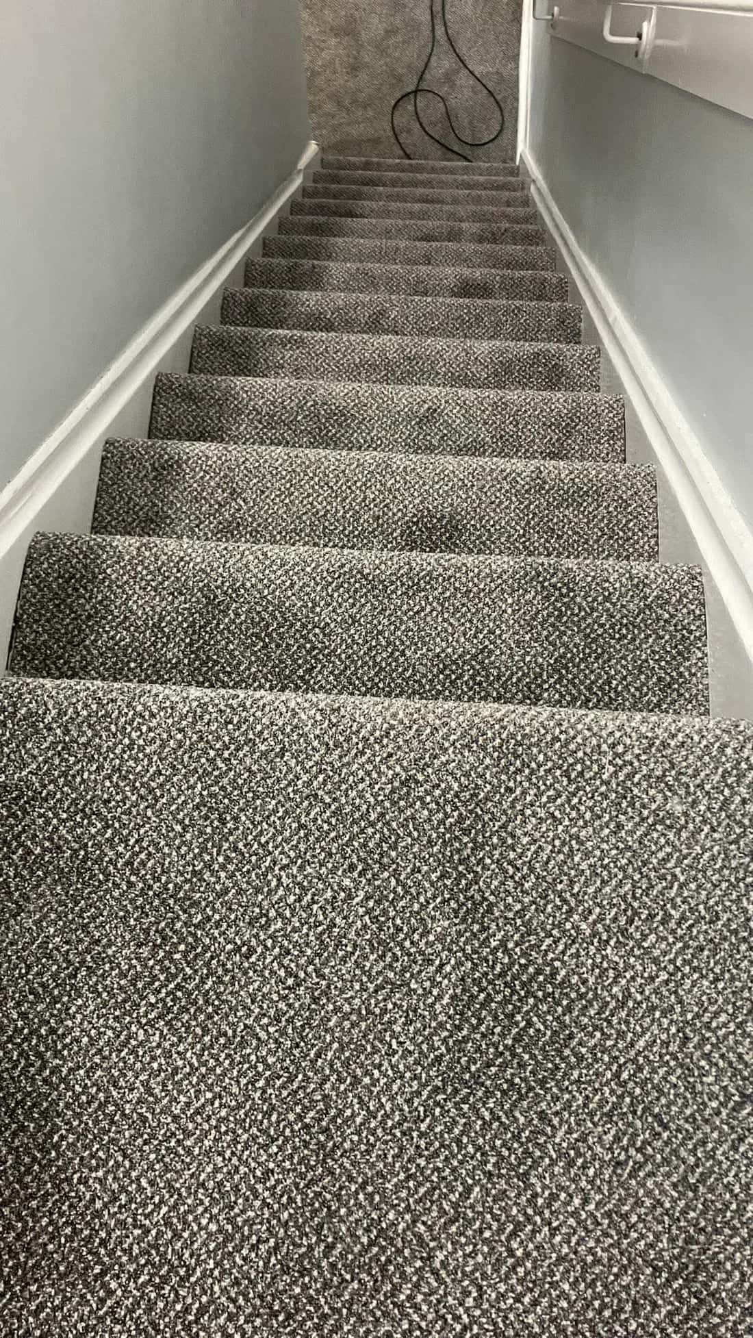 Flecked loop pile carpet fitted to a staircase