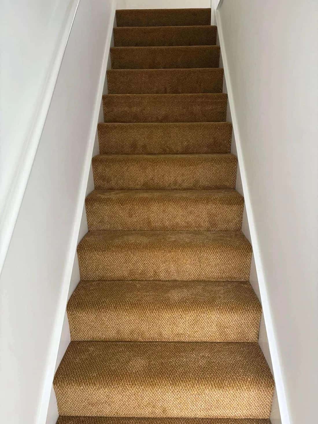 Gold carpet fitted to a staircase and landing