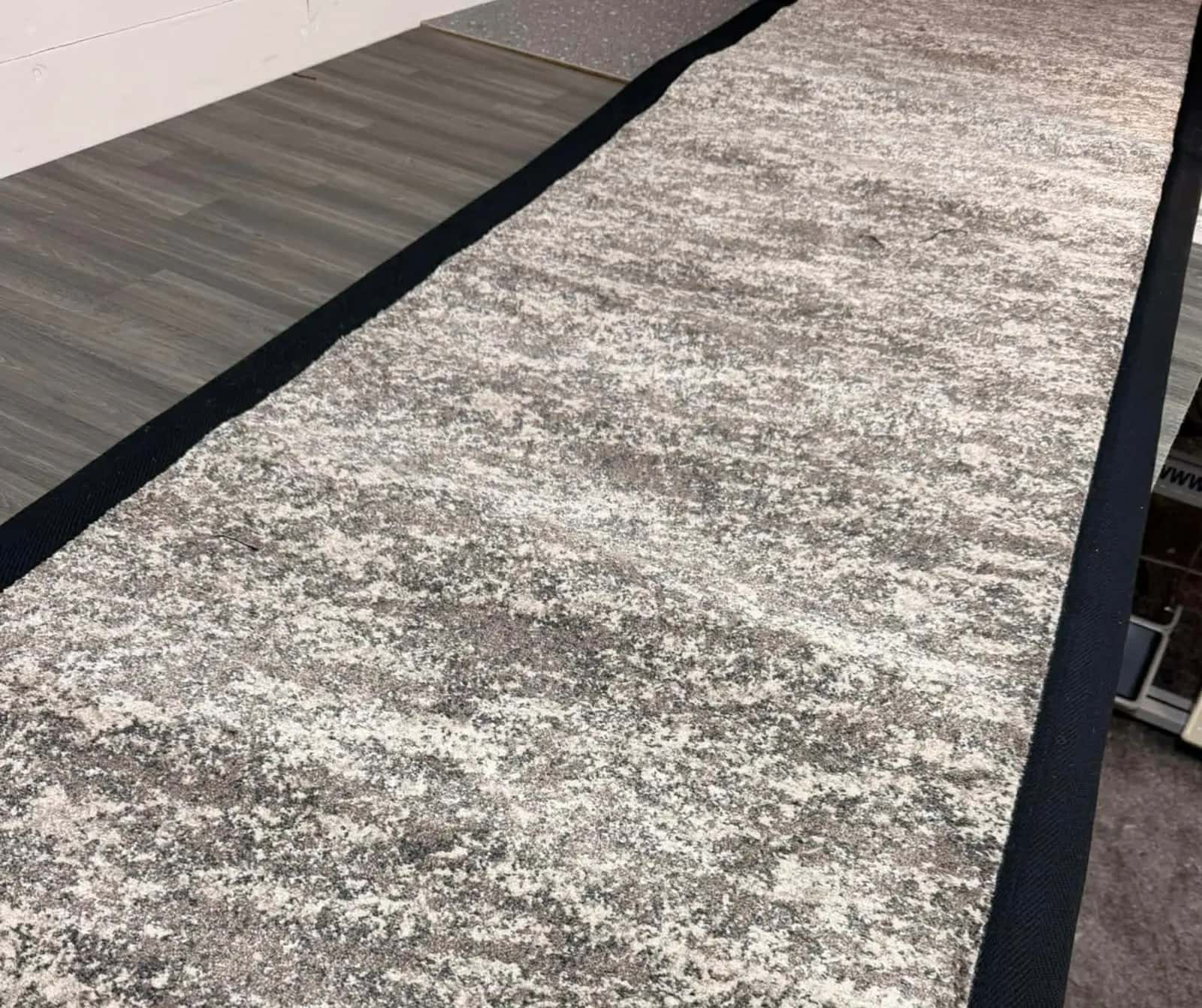 Textured carpet with a dark bound border