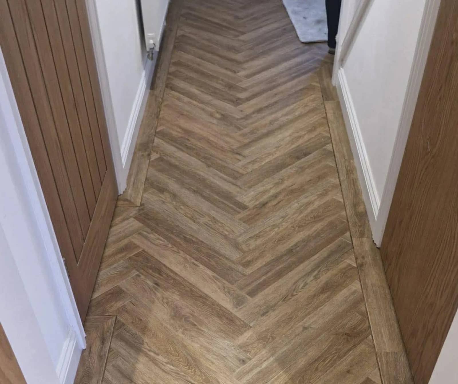 Wood effect flooring running the length of a hallway