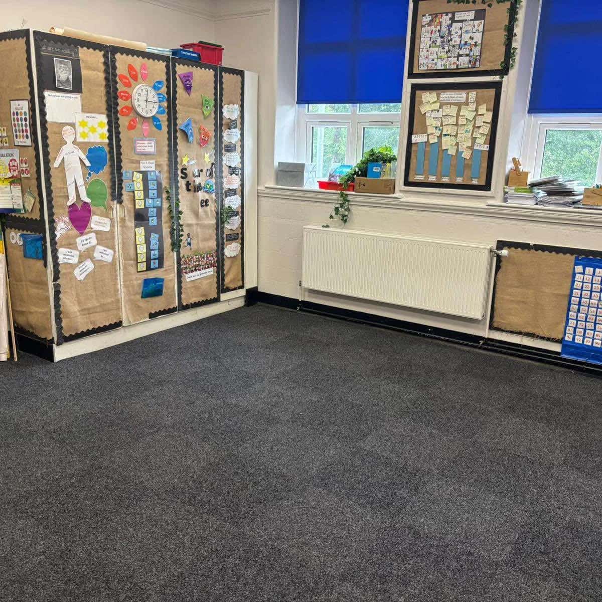 Heavy duty carpet tiles laid across a classroom floor
