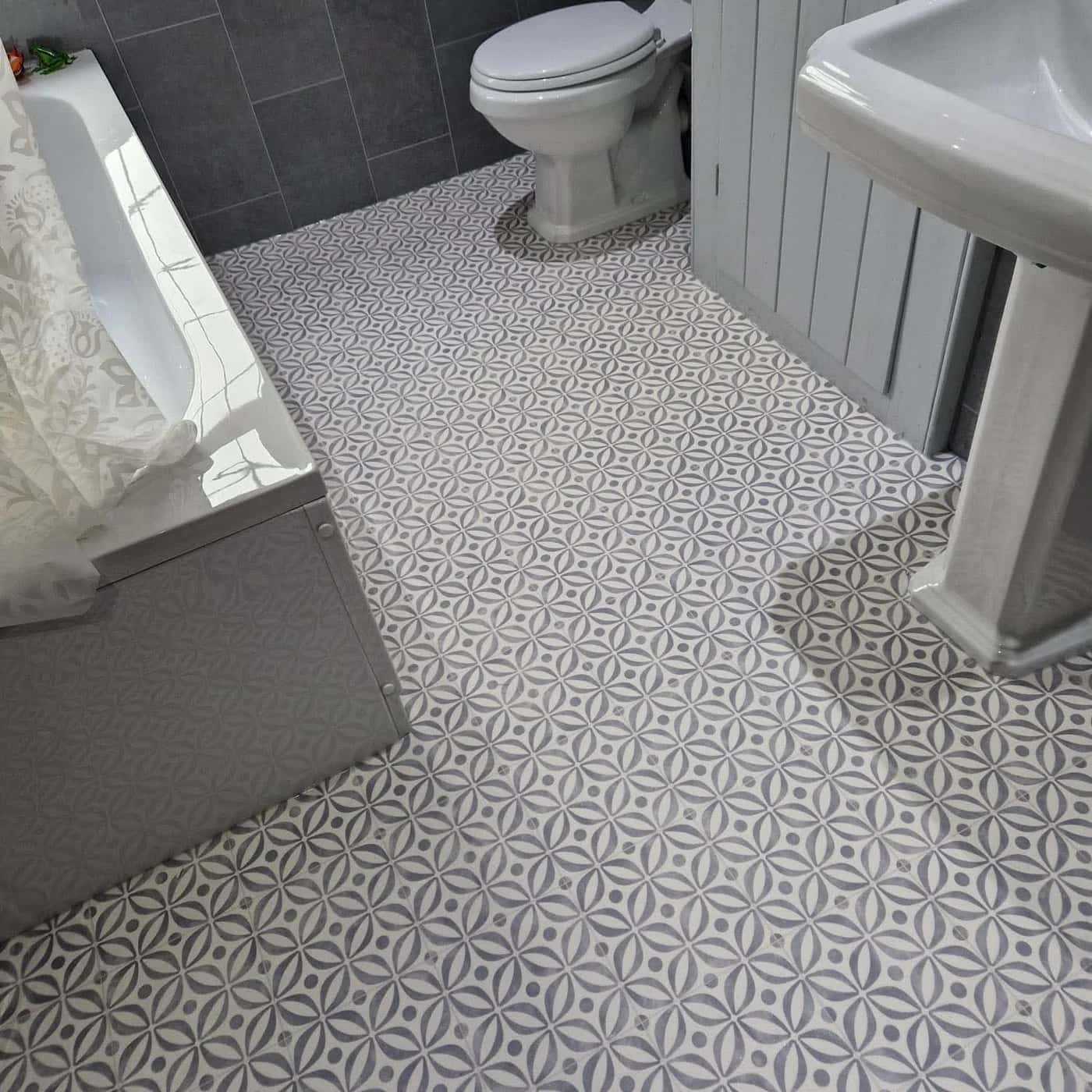 Patterned sheet vinyl fitted around a bath, basin and WC