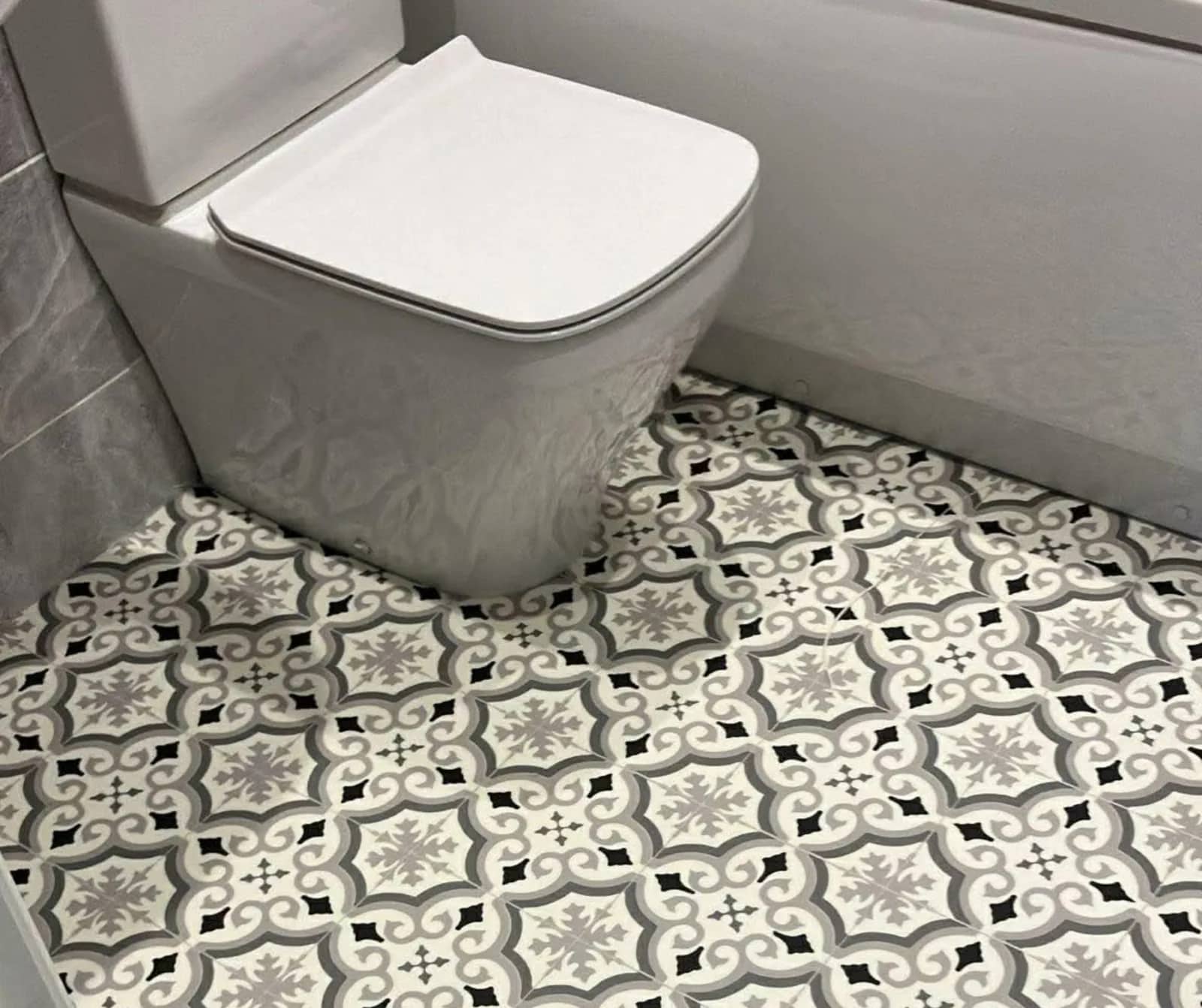 Patterned vinyl fitted around a bathroom suite