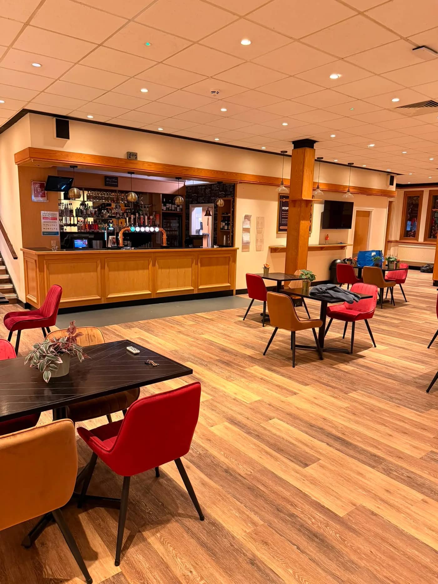 The finished bar and seating area at Burnley Mechanics on wood effect vinyl plank, with tables and chairs back in place