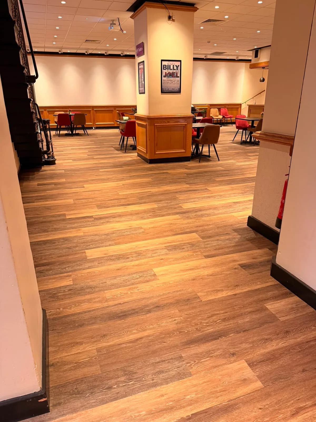 Wood effect vinyl plank running through the Burnley Mechanics foyer towards the seating area