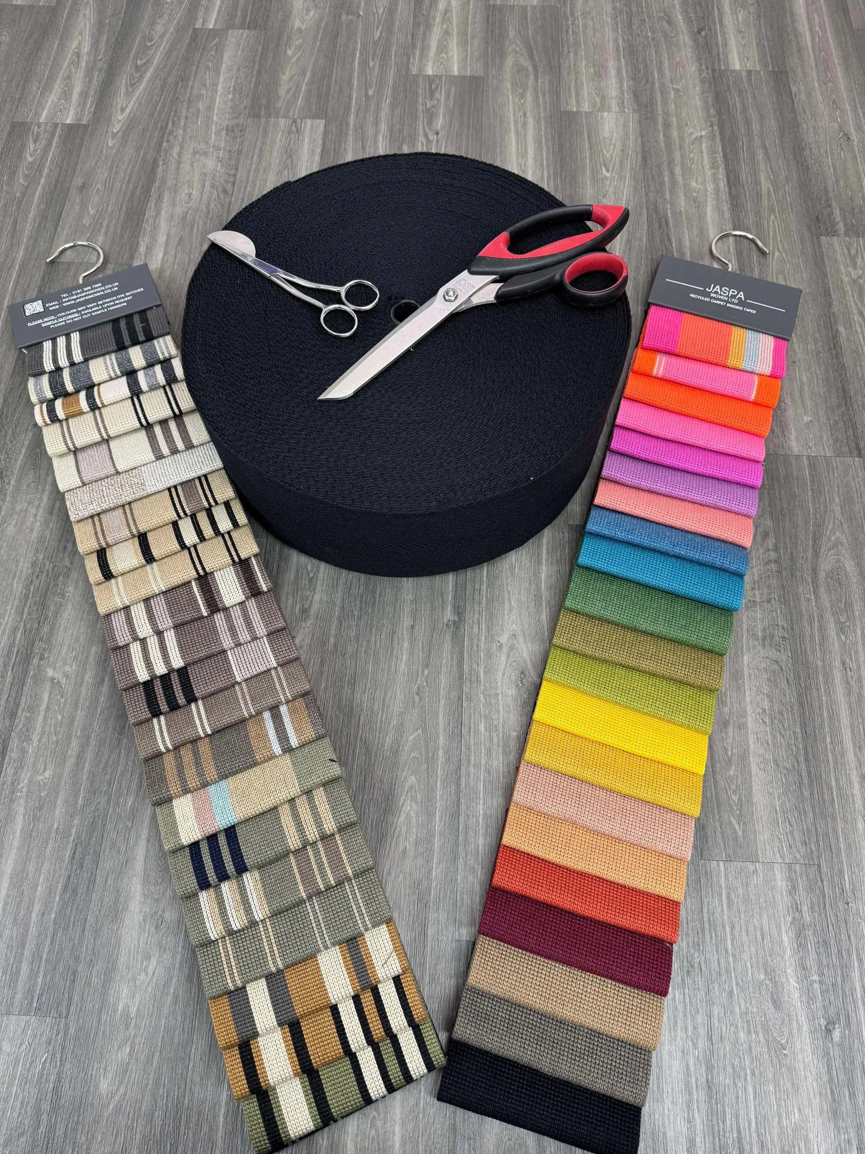 Carpet sample books and fitting shears laid out on vinyl flooring