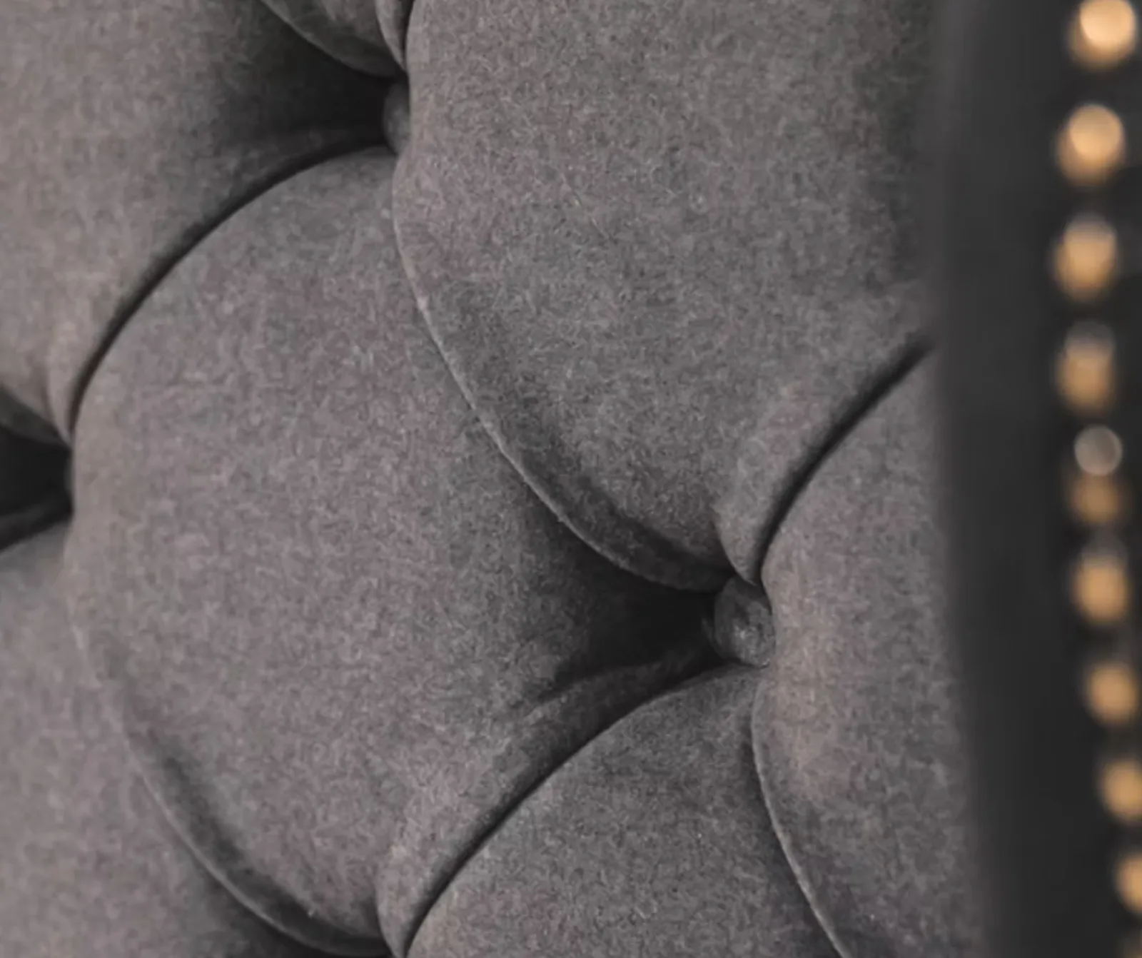 Deep buttoned upholstered headboard with a studded edge