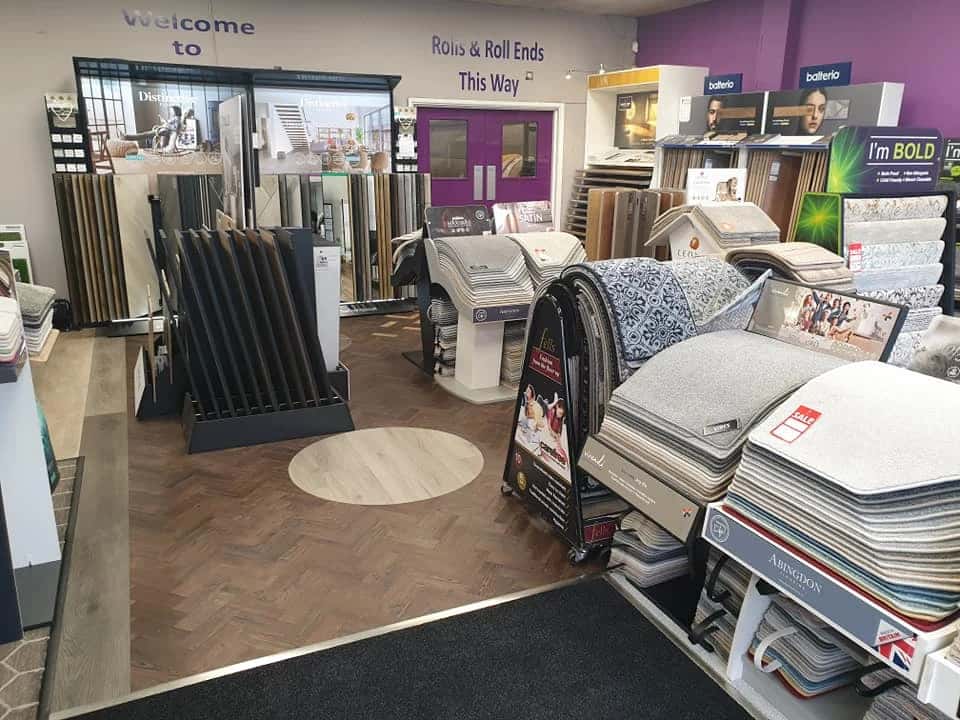 Sample stands and rolled carpet inside the showroom entrance