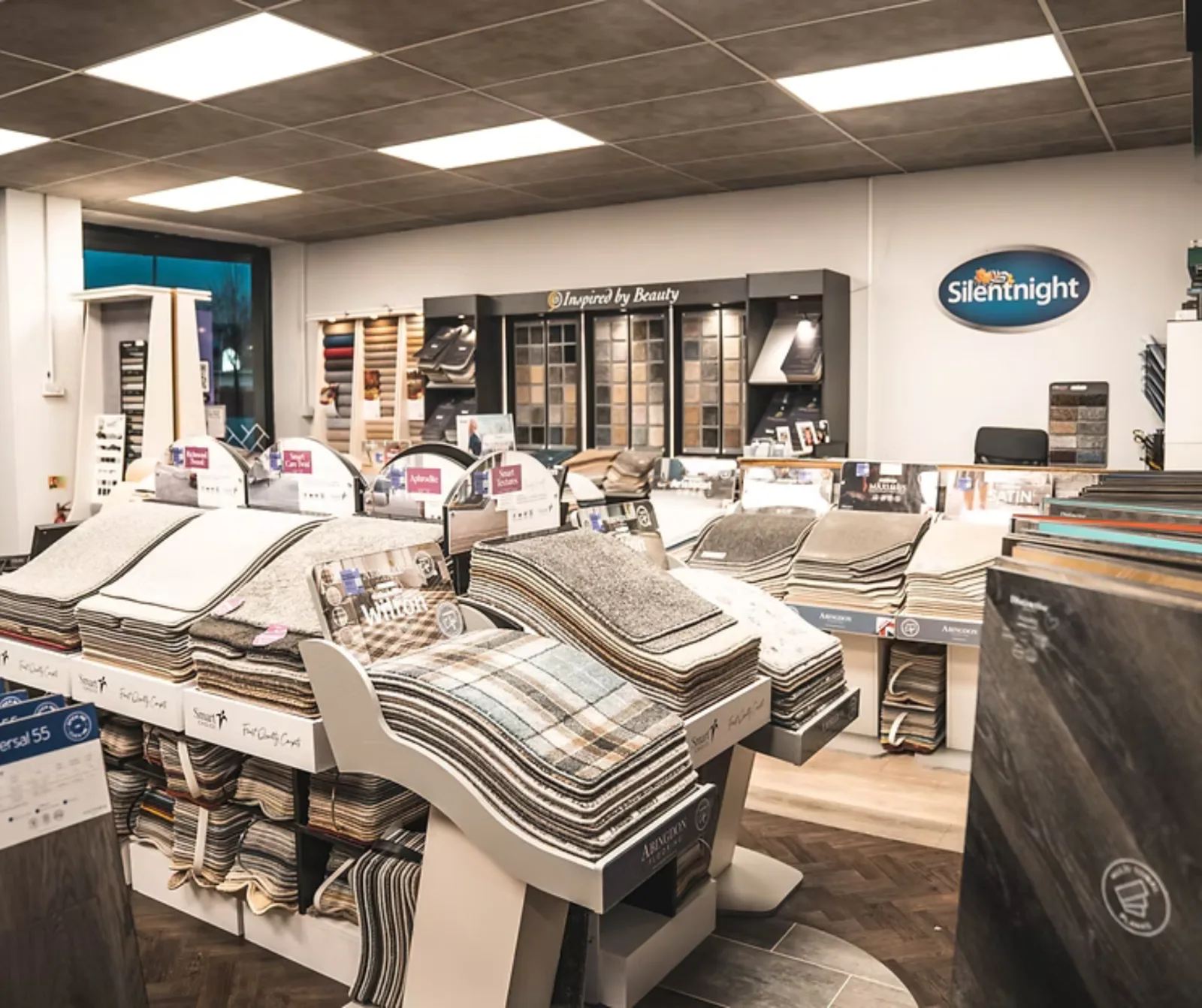Carpet sample stands and bed displays on the Boundary Carpets and Beds showroom floor in Colne