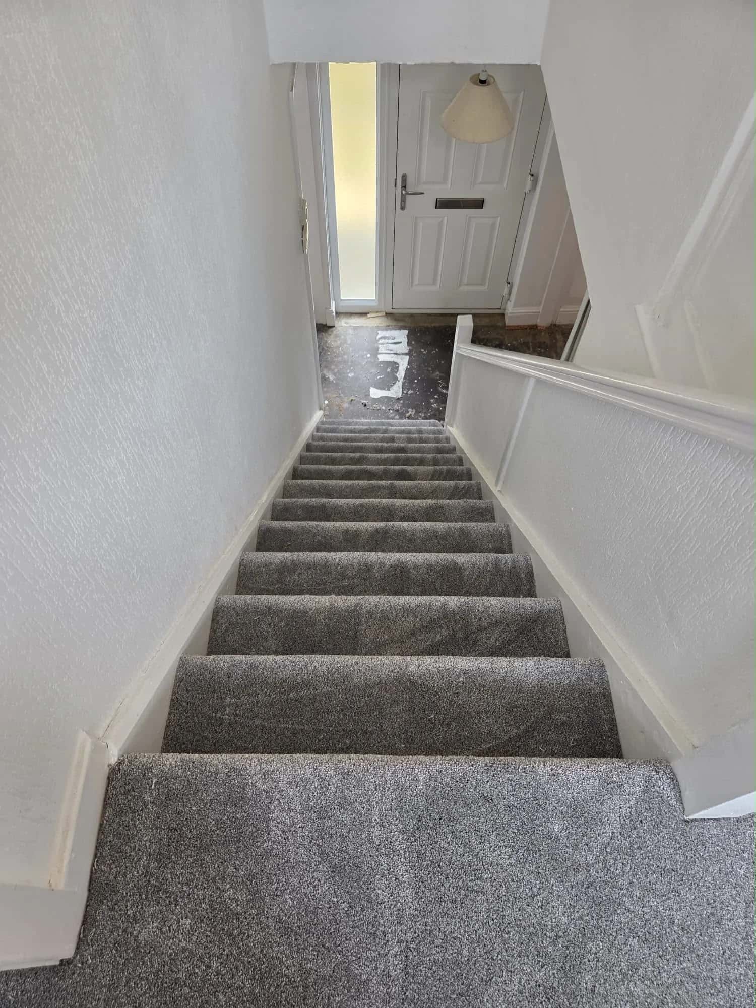 Grey carpet fitted to a staircase and hall