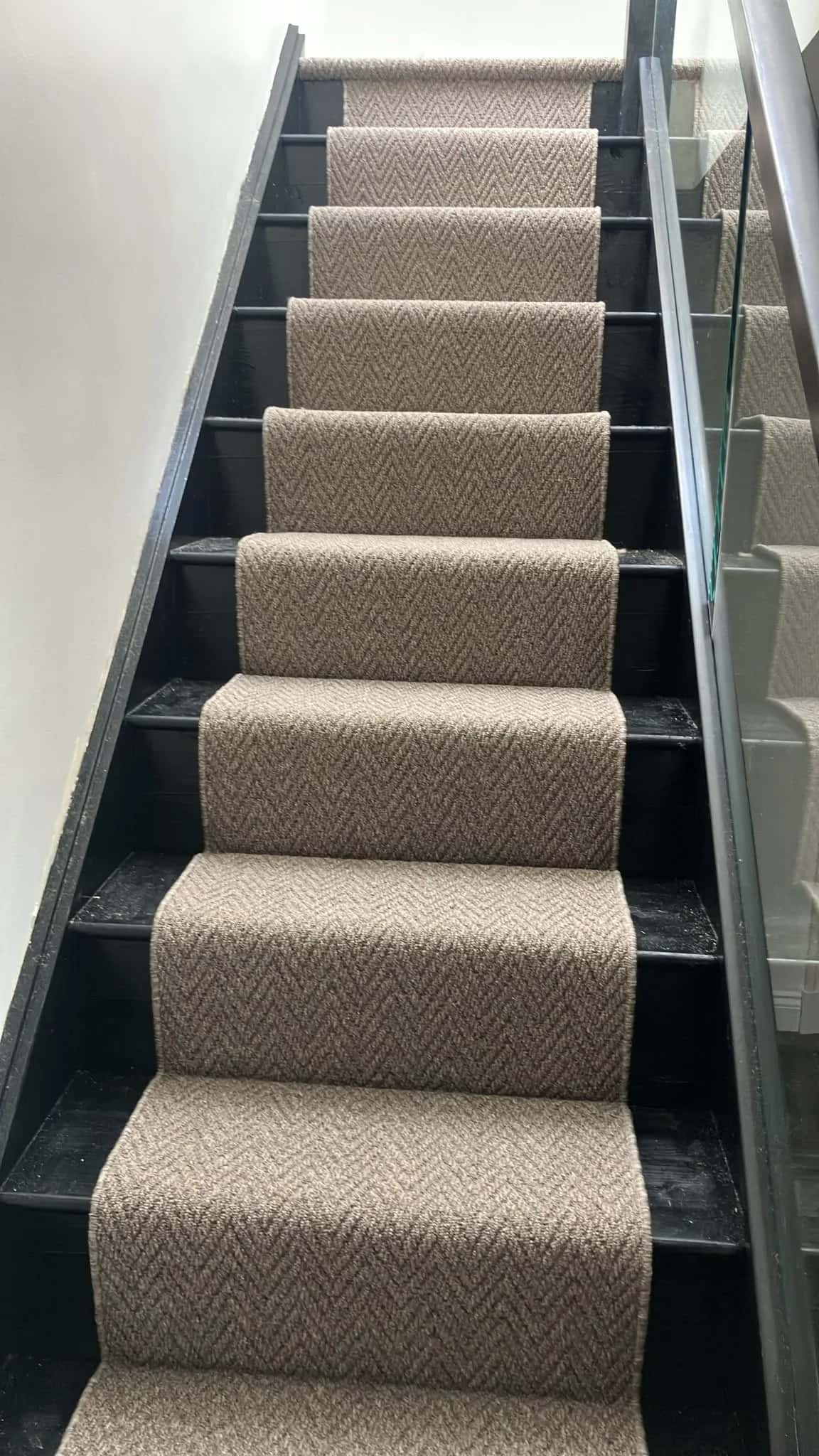 Herringbone runner fitted to a painted staircase